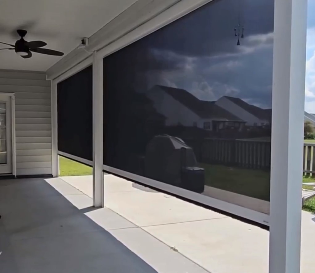 screen like panels for outdoor patio coverage are rolling up using motorization